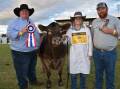 Judge Travis Luscombe, Dalby, Qld sashes his grand champion junior led steer led by Lily Moore. Also pictured is owner Ian Lamb, Manilla, NSW.